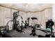 Home exercise room featuring concrete walls, rubber flooring, and multiple pieces of workout equipment at 1023 Bentley Estates Dr, Dacula, GA 30019