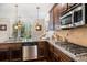 Elegant kitchen featuring granite counters, stainless appliances and hardwood floors at 1023 Bentley Estates Dr, Dacula, GA 30019