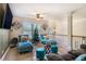 Relaxing upstairs loft features cozy seating, decorative chandelier, and plenty of natural light for a serene space at 1023 Bentley Estates Dr, Dacula, GA 30019