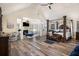 Spacious primary bedroom with hardwood floors, vaulted ceilings, and a cozy seating area at 1023 Bentley Estates Dr, Dacula, GA 30019