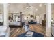 Large primary bedroom with hardwood floors, vaulted ceilings, and a sitting area at 1023 Bentley Estates Dr, Dacula, GA 30019