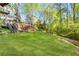 Green backyard with a small creek running along the back and multiple access points to the home at 4027 Mount Vernon Dr, Woodstock, GA 30189
