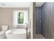 Bathroom with modern tub and grey tiled shower at 4027 Mount Vernon Dr, Woodstock, GA 30189