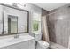 Bright bathroom featuring shower with gray tile and white vanity with framed mirror at 4027 Mount Vernon Dr, Woodstock, GA 30189