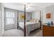 Bedroom with four post bed and neutral colored walls at 4027 Mount Vernon Dr, Woodstock, GA 30189