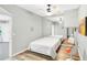 Modern bedroom with wood floor, mirror, ceiling fan, and view to a second room at 4027 Mount Vernon Dr, Woodstock, GA 30189