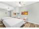 Modern bedroom with wood floor, mirror, ceiling fan, and view to a second room at 4027 Mount Vernon Dr, Woodstock, GA 30189