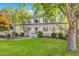 Charming two-story home with a welcoming front porch, lush green lawn, and mature trees creating a serene setting at 4027 Mount Vernon Dr, Woodstock, GA 30189