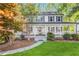 Inviting two-story home featuring a classic white exterior, dark shutters, and a spacious, covered front porch at 4027 Mount Vernon Dr, Woodstock, GA 30189