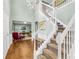 Grand foyer with hardwood floors, staircase, chandelier, and view into the office at 4027 Mount Vernon Dr, Woodstock, GA 30189