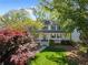 Charming two-story home with a covered front porch and lush landscaping, offering great curb appeal at 4027 Mount Vernon Dr, Woodstock, GA 30189