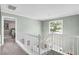 Upstairs hallway with railing and window view at 4027 Mount Vernon Dr, Woodstock, GA 30189
