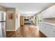 Open-concept kitchen area with white cabinets, hardwood floors, and view into the living room at 4027 Mount Vernon Dr, Woodstock, GA 30189