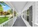 Long covered porch featuring gray decking, white railings and exterior wall, and dark window shutters at 4027 Mount Vernon Dr, Woodstock, GA 30189