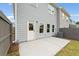 Back of the house with a small concrete patio, gray siding, a fenced-in yard and green grass at 4541 Moray Dr, Mableton, GA 30126