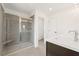 Modern bathroom featuring a glass-enclosed shower with a bench and a double sink vanity with white countertop at 4541 Moray Dr, Mableton, GA 30126