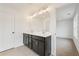 Bathroom featuring a double sink vanity, tiled floor, a large mirror with modern lighting, and entry to bedroom at 4541 Moray Dr, Mableton, GA 30126