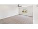 Large carpeted bedroom with one window and plain white walls and ceilings at 4541 Moray Dr, Mableton, GA 30126