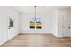 Bright dining room featuring luxury vinyl plank flooring and a modern light fixture at 4541 Moray Dr, Mableton, GA 30126