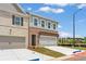 New brick and siding home with a two car garage and a gray front door at 4541 Moray Dr, Mableton, GA 30126