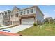 New construction home featuring brick, gray siding, a pergola, and an attached two-car garage at 4541 Moray Dr, Mableton, GA 30126