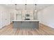 Open kitchen with a spacious center island, pendant lights, and stainless steel appliances at 4541 Moray Dr, Mableton, GA 30126