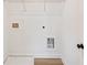 Bright laundry room with white walls, a wire shelf, and door to access the machines at 4541 Moray Dr, Mableton, GA 30126