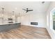 Open concept living area with luxury vinyl plank flooring, kitchen, modern fireplace, and ceiling fan at 4541 Moray Dr, Mableton, GA 30126
