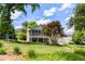 Expansive backyard featuring a well maintained lawn, mature trees, and a home with a screened in porch at 635 Stone Harbor Sw Pkwy, Marietta, GA 30060