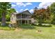 Backyard featuring large grassy area, mature trees, wooded area, screened in back porch, and an outdoor bench at 635 Stone Harbor Sw Pkwy, Marietta, GA 30060