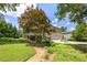 Backyard featuring a long grassy area, mature trees, a screened in porch, and a two car garage at 635 Stone Harbor Sw Pkwy, Marietta, GA 30060