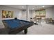 Finished basement featuring a pool table, seating area, modern artwork, and natural light from the window at 635 Stone Harbor Sw Pkwy, Marietta, GA 30060