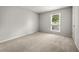 Bright bedroom features neutral paint, plush carpeting, and a large window at 635 Stone Harbor Sw Pkwy, Marietta, GA 30060