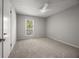 Bedroom showcasing a ceiling fan, window with a view, and neutral paint at 635 Stone Harbor Sw Pkwy, Marietta, GA 30060