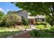 Charming home featuring lush landscaping, inviting walkway, and a welcoming entrance with pergola at 635 Stone Harbor Sw Pkwy, Marietta, GA 30060