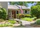 Inviting front porch, adorned with a quaint walkway and framed by lush landscaping and decorative bushes at 635 Stone Harbor Sw Pkwy, Marietta, GA 30060