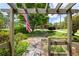 View of a stone walkway and vibrant landscaping leading to a home with American flag in the distance at 635 Stone Harbor Sw Pkwy, Marietta, GA 30060