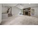 Large living room featuring neutral walls, plush carpeting, a stone fireplace, and a ceiling fan at 635 Stone Harbor Sw Pkwy, Marietta, GA 30060