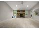 Spacious living room with plush carpeting, a stone fireplace, and bright natural light from a nearby window at 635 Stone Harbor Sw Pkwy, Marietta, GA 30060