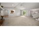 Open living room featuring a stone fireplace, neutral tones, and seamless flow to other areas at 635 Stone Harbor Sw Pkwy, Marietta, GA 30060