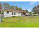 This backyard boasts a well-kept lawn and a rustic fence, creating a serene outdoor space at 95 Stephens Dr, Covington, GA 30016