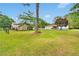 Private backyard featuring a mix of trees, a well-maintained lawn, and a secure fence for privacy at 95 Stephens Dr, Covington, GA 30016