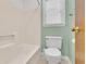 Bathroom with combination tub and shower and window for natural light at 95 Stephens Dr, Covington, GA 30016