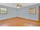 Bedroom with wood floors, two windows and a ceiling fan at 95 Stephens Dr, Covington, GA 30016