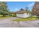 A white single story home with a two car garage and a long driveway at 95 Stephens Dr, Covington, GA 30016