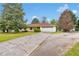 Single story home featuring a large driveway, front yard, and a two car garage at 95 Stephens Dr, Covington, GA 30016