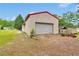 Large barn with a red roof and a roll up garage door, sitting on a grass and gravel lot at 95 Stephens Dr, Covington, GA 30016
