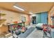 Garage interior featuring work bench, TV, shelving, bed, and metal siding at 95 Stephens Dr, Covington, GA 30016