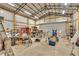 Bright barn interior with high ceilings, metal frame, overhead lights, workbench, and lots of tools at 95 Stephens Dr, Covington, GA 30016