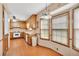 Kitchen and dining area with wood floors, cabinetry, and double windows for natural light at 95 Stephens Dr, Covington, GA 30016